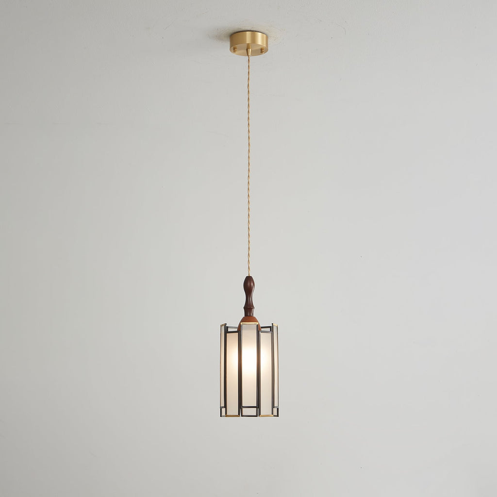 Small Clérachic frosted-panel pendant on a long twisted cord from a brass ceiling canopy, against a pale grey wall.