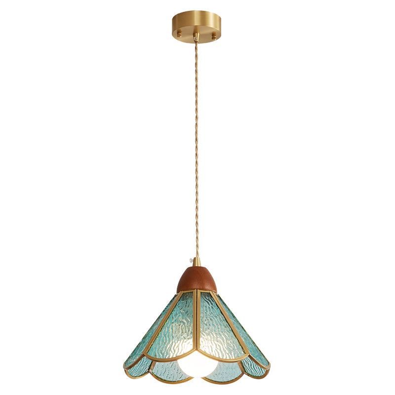 Teal Clérachic pendant on a short cord from a brass canopy, its rippled glass shade lit, on a white backdrop.