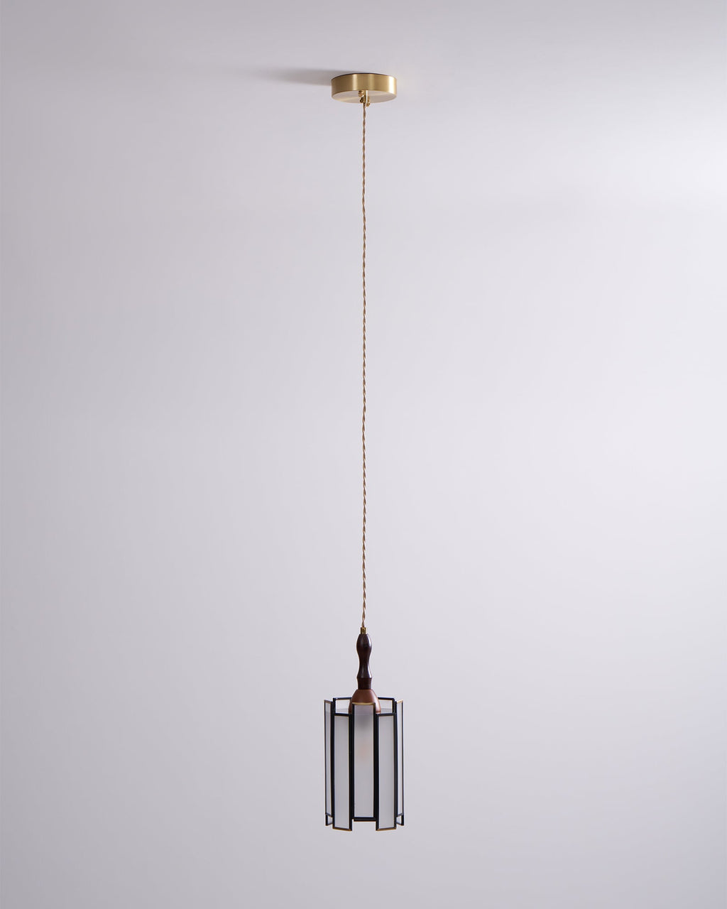 Small Clérachic frosted-panel pendant on a long cord from a brass canopy, against a soft lilac-grey wall.