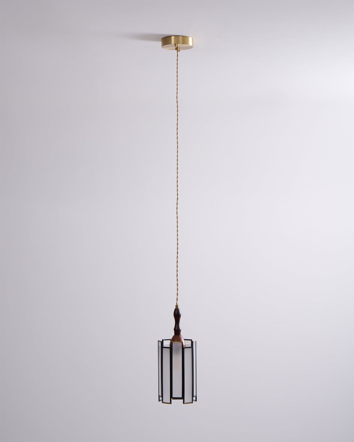 Small Clérachic frosted-panel pendant on a long cord from a brass canopy, against a soft lilac-grey wall.