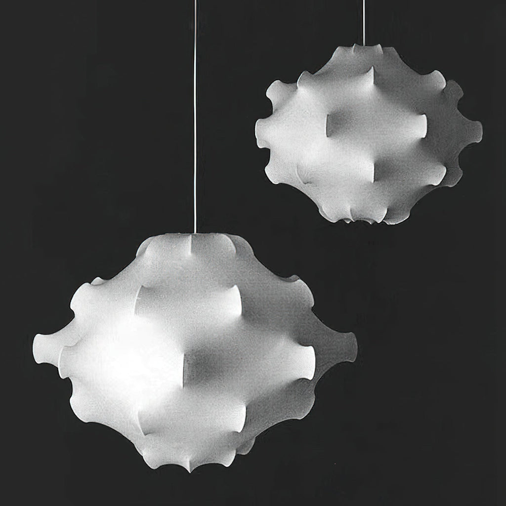 Black-and-white photo of two white Clérachic pendants of different sizes against a dark background.