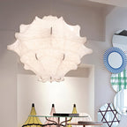 A large white Clérachic pendant seen from below, with its stitched seams visible, beside striped round mirrors.