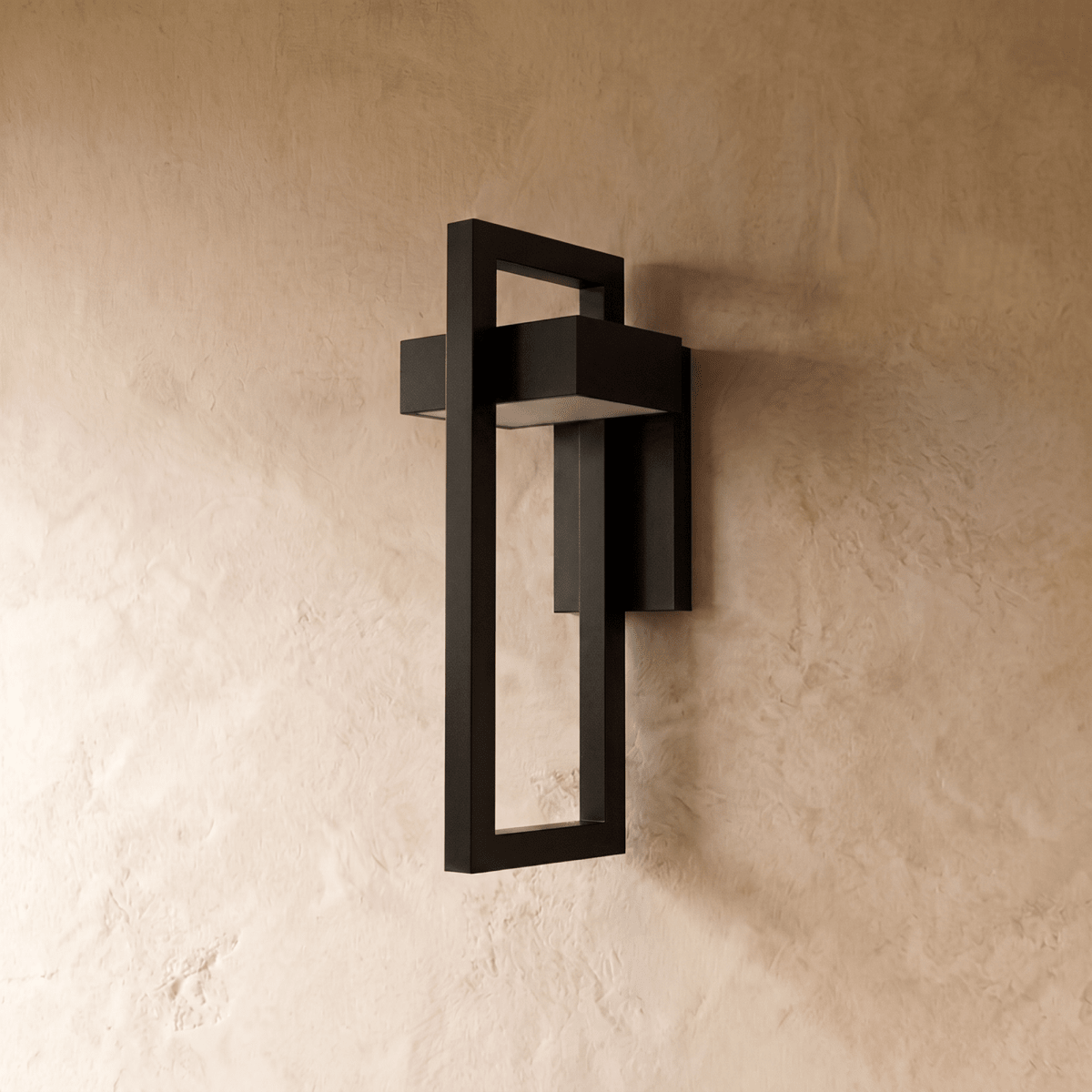 Side angle of the Clérachic steel wall light shows its layered rectangular frame casting a soft glow on plaster.