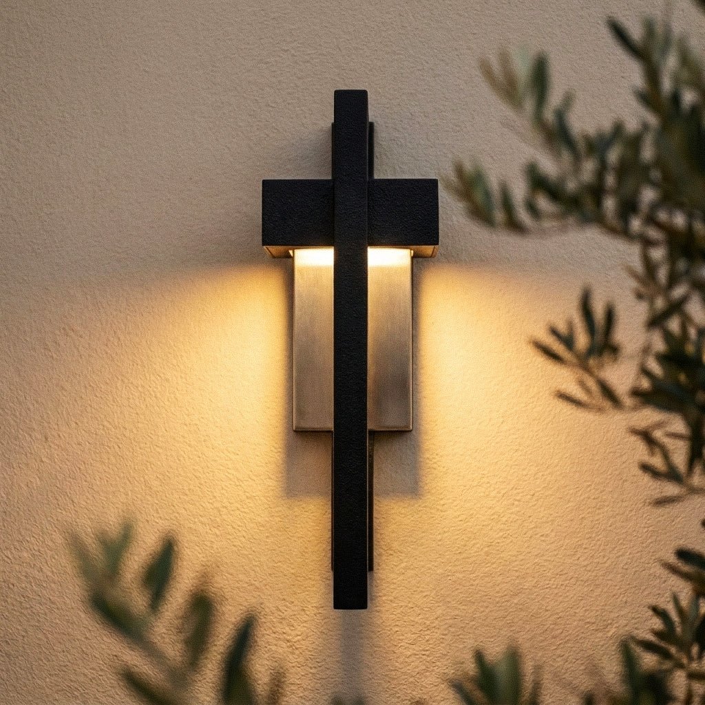 Macro detail of the Clérachic wall light shows its black steel cross-frame over a warm brass-toned light bar.