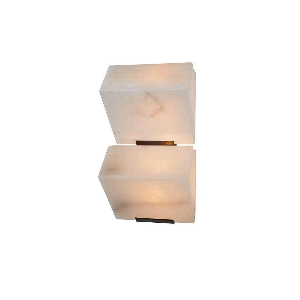 Cut-out view of a two-block Clérachic alabaster wall light, the veined stone glowing warm above its black wall plates.