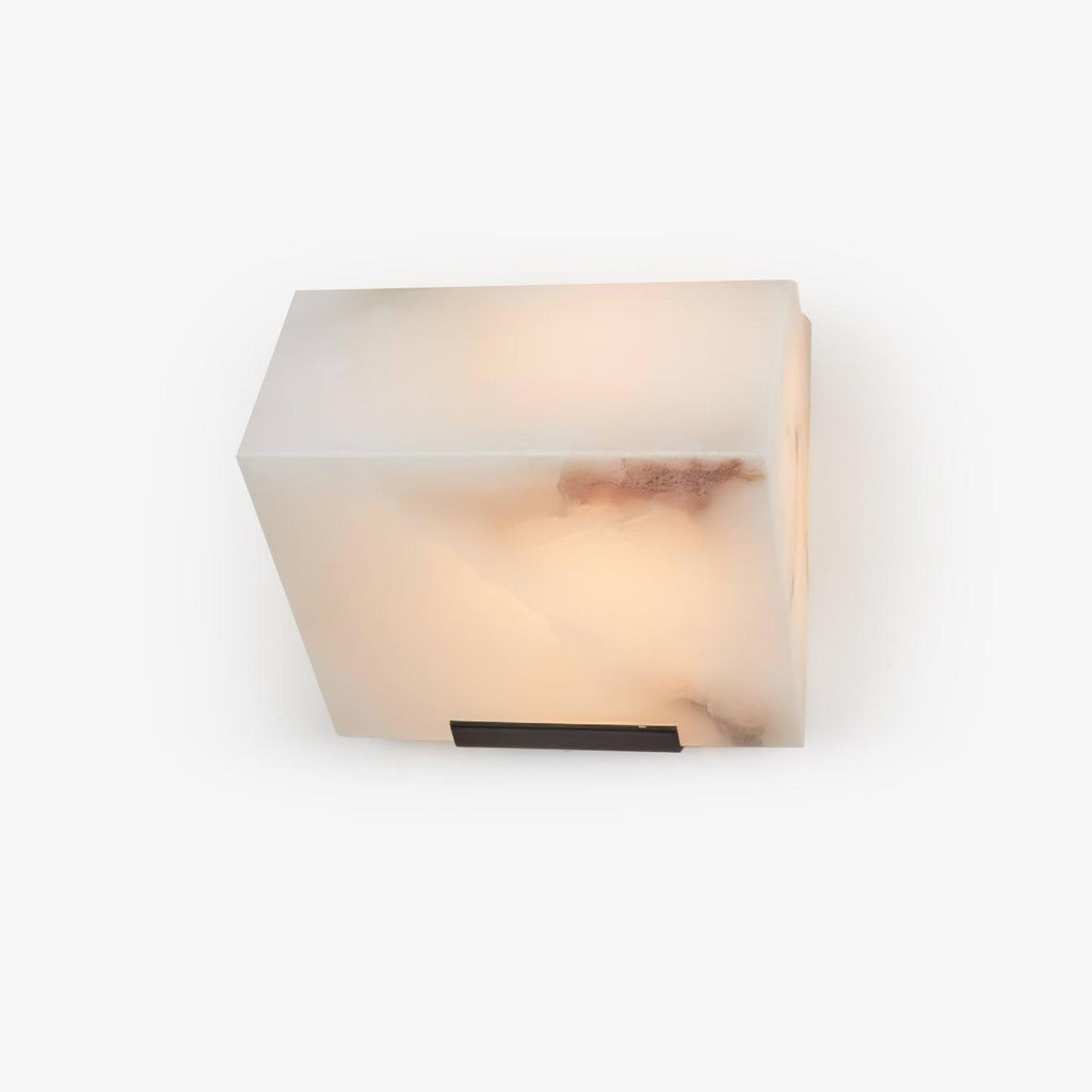 A single Clérachic alabaster block wall light on white, with dark rose veining in the stone and a black plate beneath.