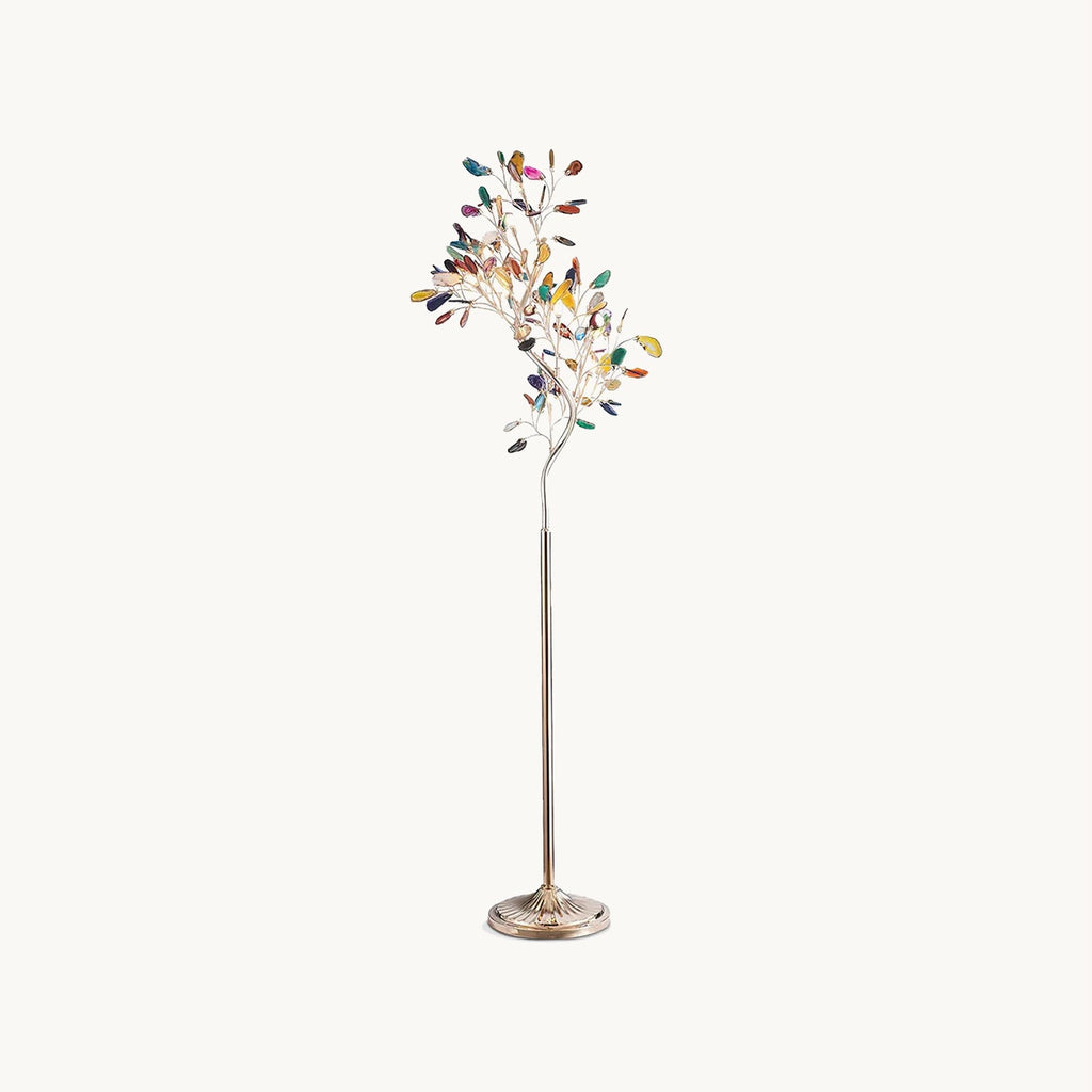 This Clérachic floor lamp on a plain backdrop, a slim gold stem branching into a tree of coloured agate slices above a round gold base.