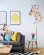 A Clérachic agate floor lamp and a small matching table version in a living room with a grey sofa and bright cushions.