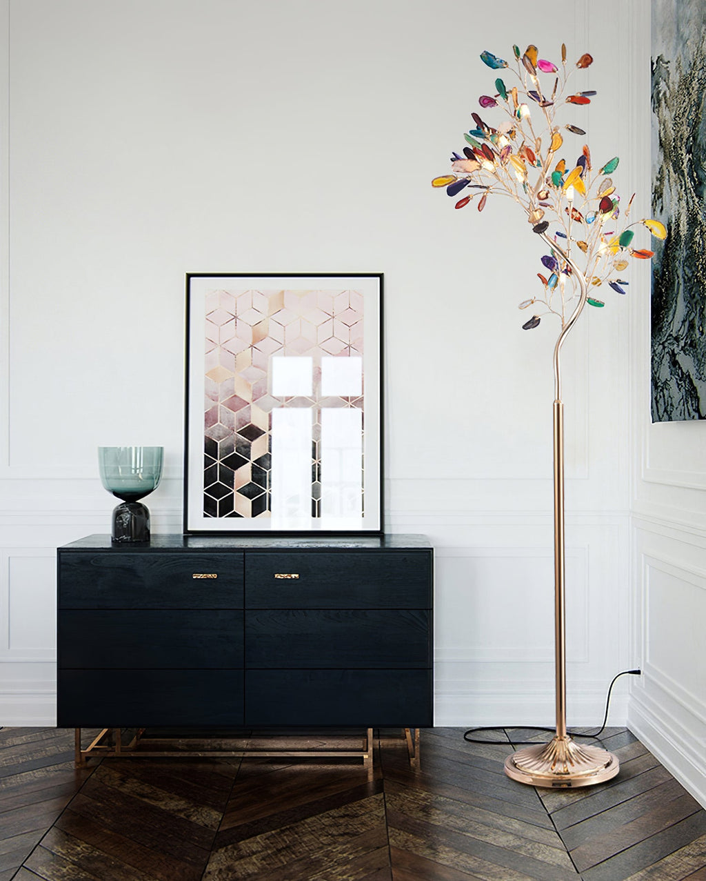 Clérachic agate floor lamp beside a black sideboard and a framed geometric print, on a dark wood herringbone floor.