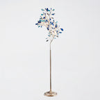 Clérachic agate floor lamp with blue and teal slices on thin gold branches, on a pale grey backdrop.