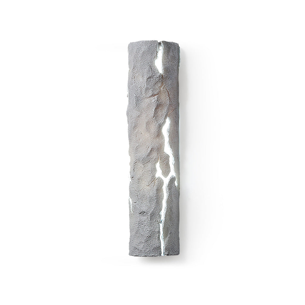 Grey stone-look wall light with a white glowing crack, shown straight on against white, a Clérachic wall light.