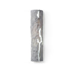 Grey stone-look wall light with a white glowing crack, shown straight on against white, a Clérachic wall light.