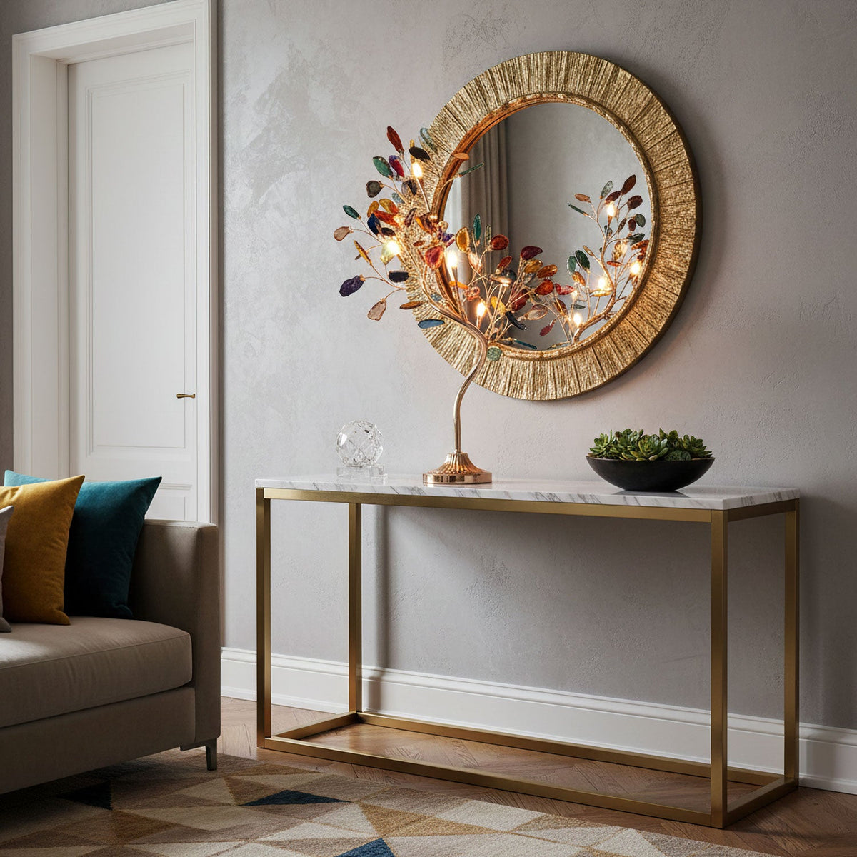 Table lamp with glowing agate leaves from Clérachic, on a brass-framed console in front of a round gold sunburst mirror.