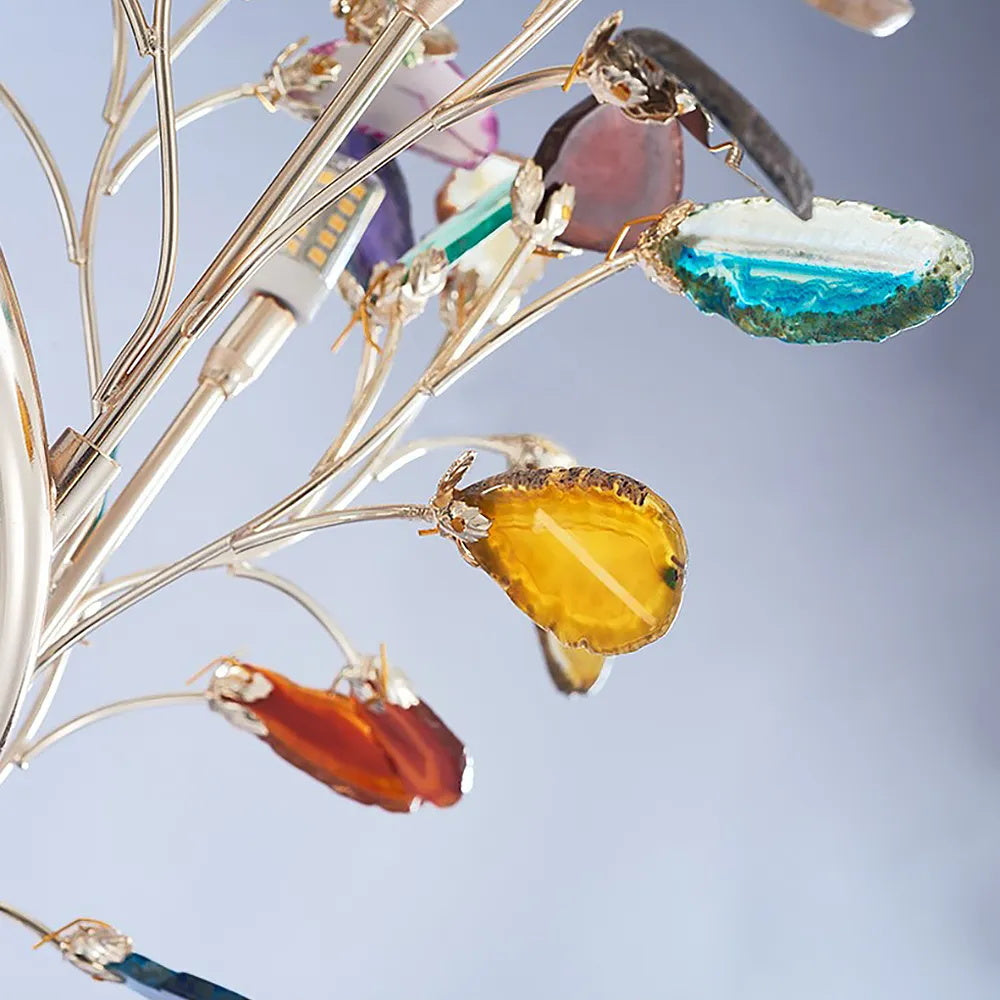 Detail of agate slices in blue, yellow and amber held in small metal claws on the branches of this Clérachic table lamp.