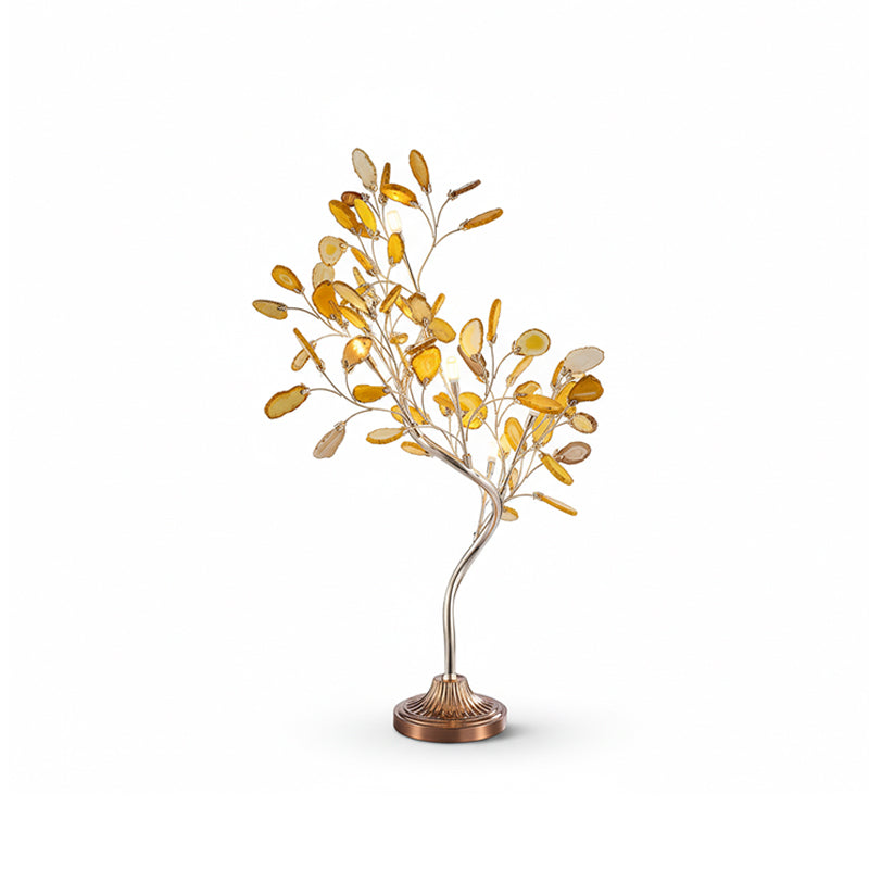 A Clérachic tree table lamp with yellow-gold agate leaves on a curved stem, shown unlit on a white backdrop.