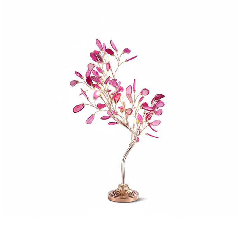 Pink agate leaves cover the branches of this Clérachic table lamp, lit softly on a white backdrop.