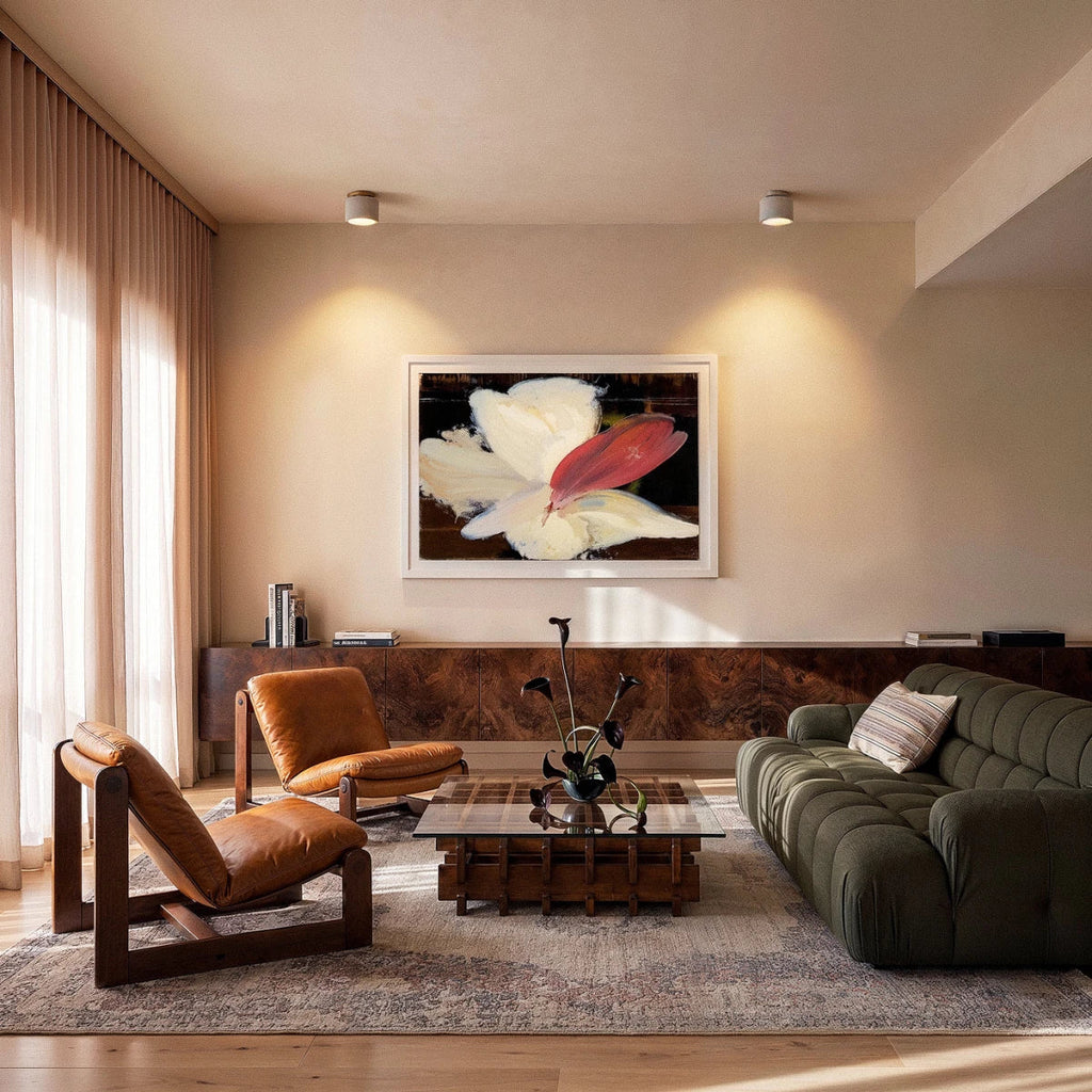 Clérachic two small drum ceiling lights lit warm above a living room with tan leather chairs and a green modular sofa.