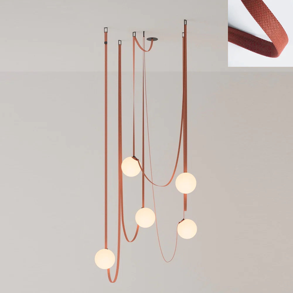 Five red canvas straps of the Clérachic Strap-Hung Glass Globe Pendant Light, each hung from its own ceiling hook at a different length.