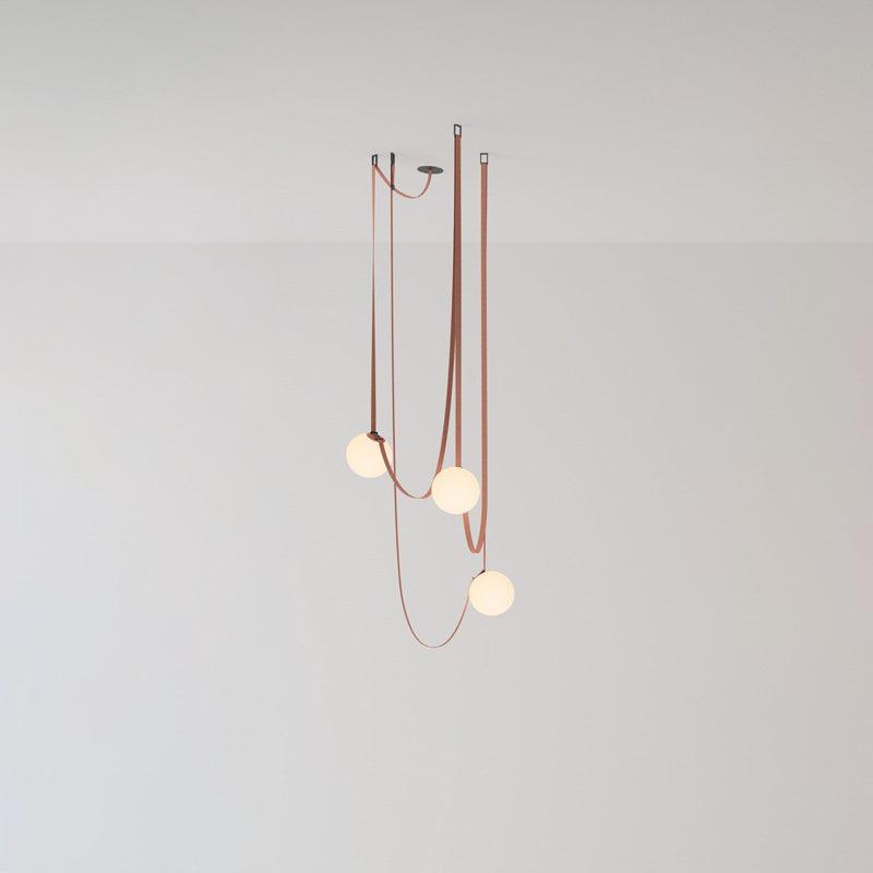 Compact studio view of the Clérachic Strap-Hung Glass Globe Pendant Light, three red canvas straps carrying globes to different depths against a plain backdrop.