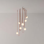 Studio view of a larger Clérachic Strap-Hung Glass Globe Pendant Light cluster, its rust canvas straps carrying globes to varied drop heights.