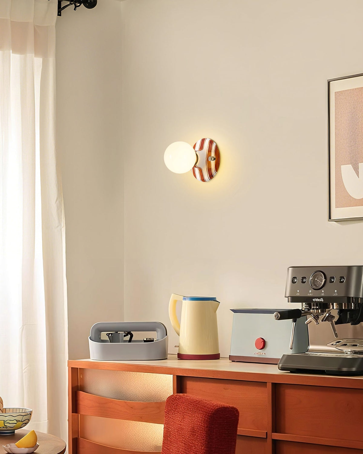 Distant view of a Clérachic wall light with a brown and white striped backplate above a wooden sideboard and a cream kettle.