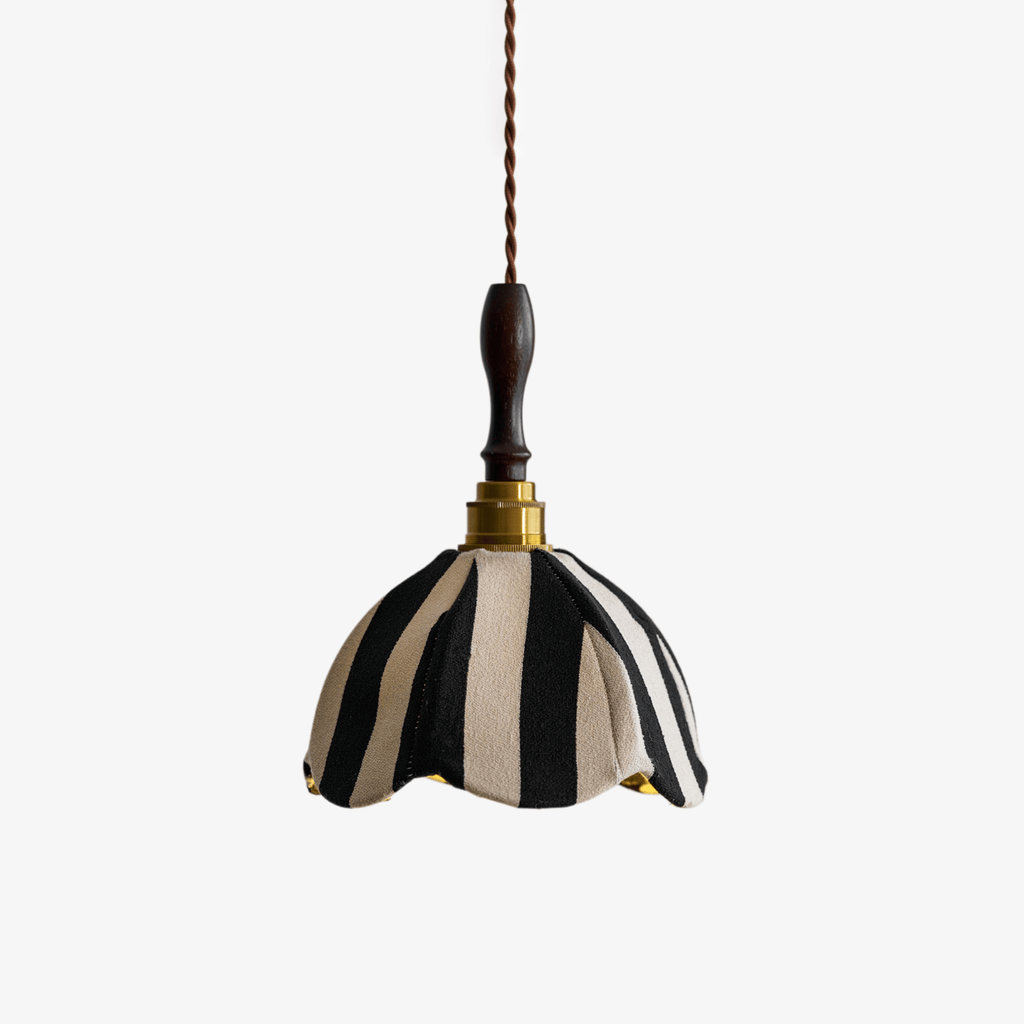 Black-and-cream striped fabric pendant with a scalloped hem, a brass collar and a dark wood finial, on a plain backdrop, from Clérachic.