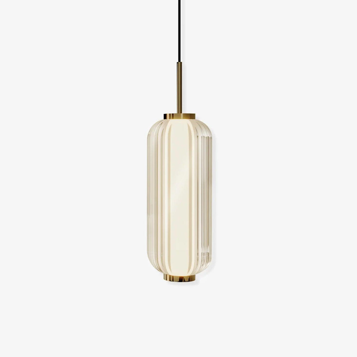 A ribbed glass cylinder pendant with gold fittings, shown lit on a plain off-white backdrop, from Clérachic.
