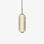 A ribbed glass cylinder Clérachic pendant with a gold stem and caps, in a champagne-tinted version on an off-white backdrop.