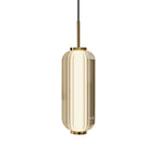 A larger ribbed glass cylinder Clérachic pendant in champagne-tinted glass, with a gold stem and collars, on a white backdrop.