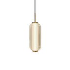 A smaller ribbed glass cylinder Clérachic pendant in champagne-tinted glass with a gold stem, on a white backdrop.