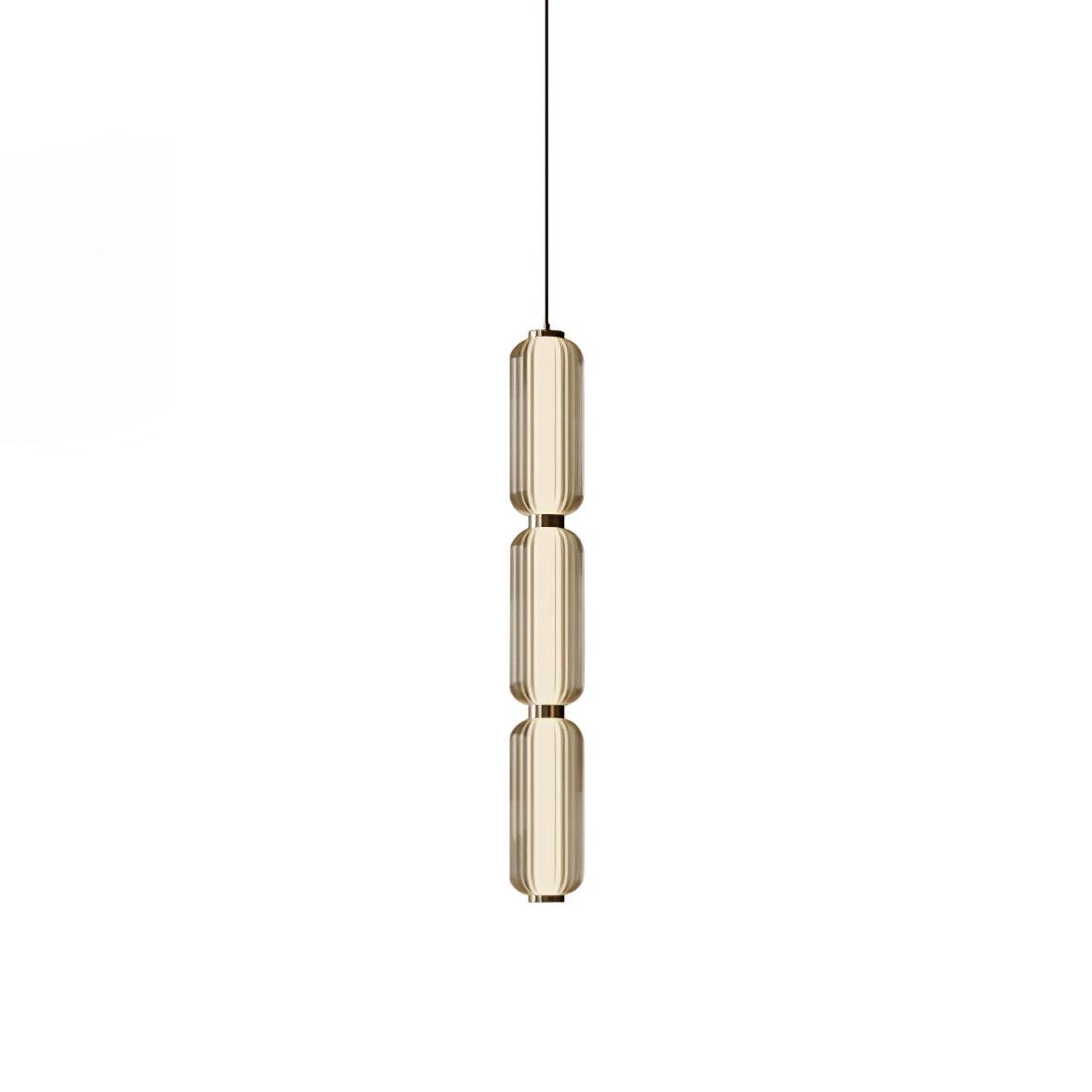 A slim three-tier Clérachic pendant in champagne-tinted ribbed glass with gold collars and a thin black cord, on white.