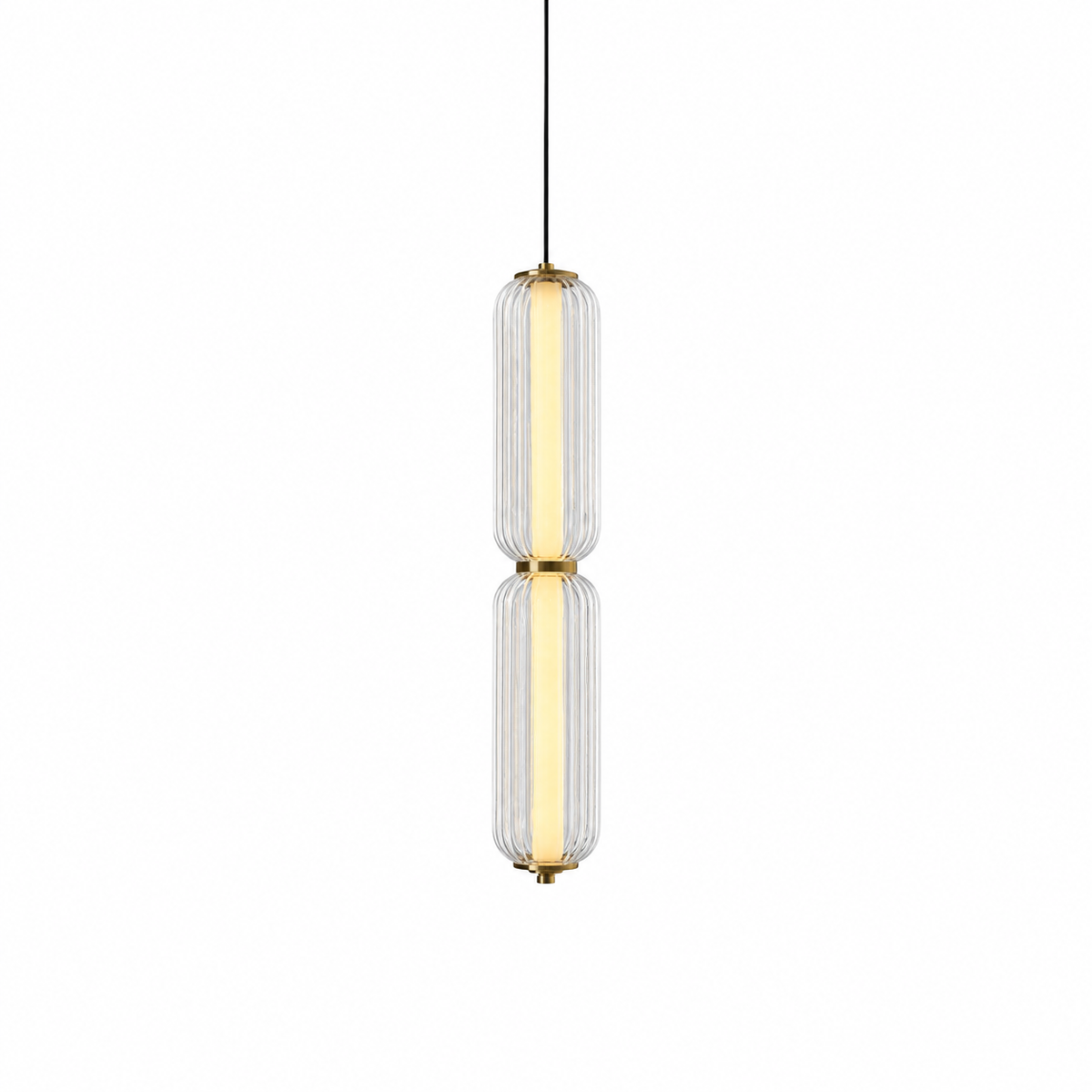 A slim two-tier Clérachic pendant in clear ribbed glass with a warm glowing inner tube and gold collars, on white.