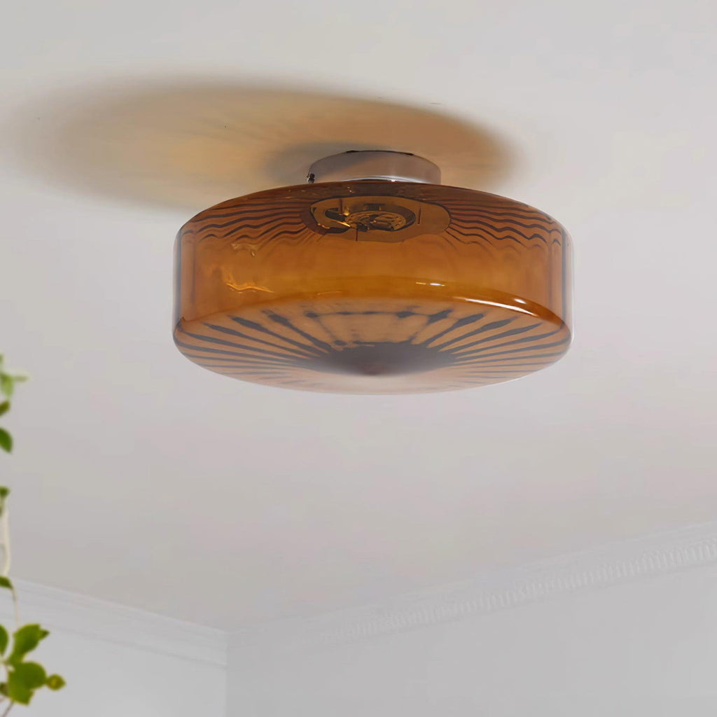 Switched off, the Clérachic Sunburst Amber Glass Flush Mount Ceiling Light reads as deep rust-amber marble streaked with grey-blue.