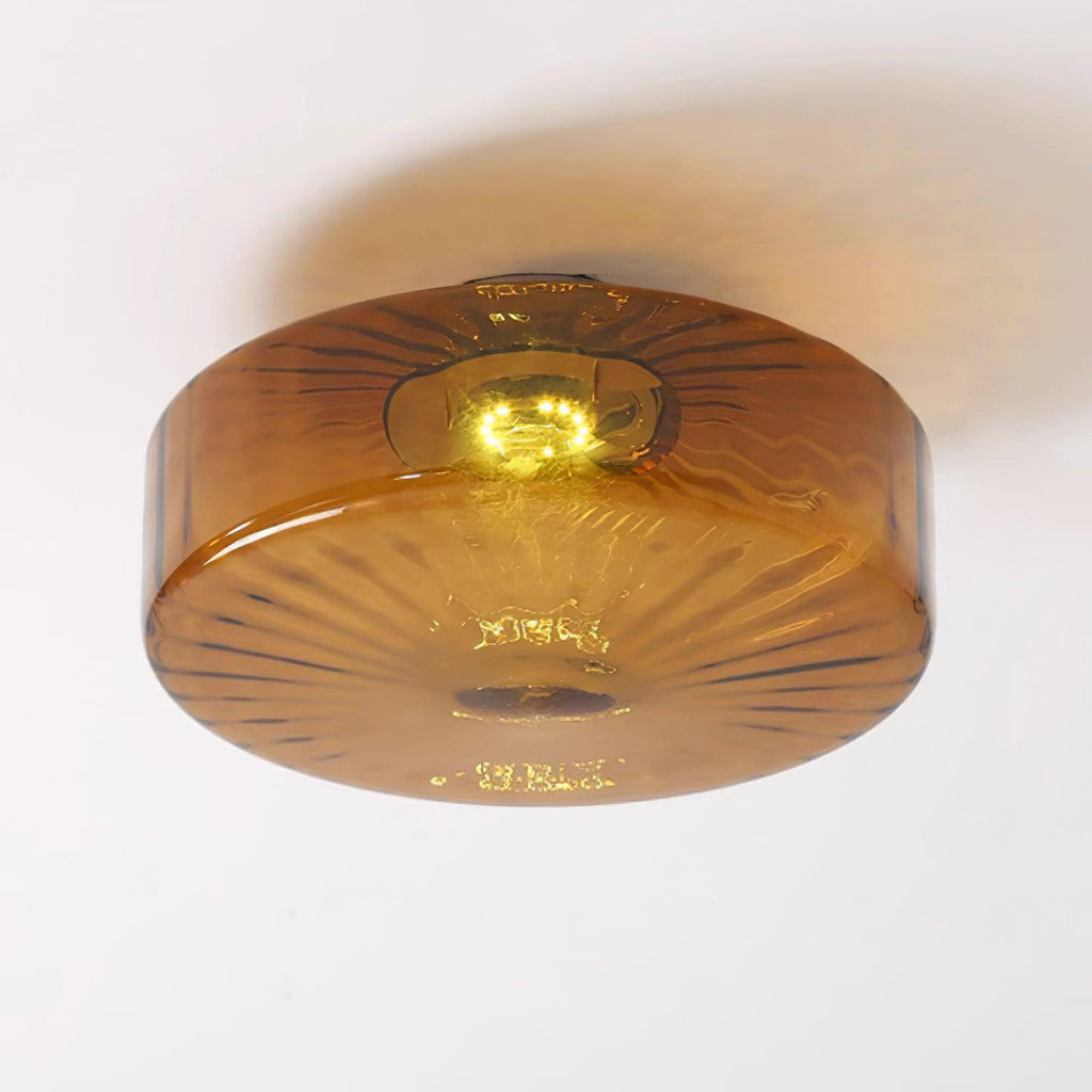 Underside view of the Clérachic Sunburst Amber Glass Flush Mount Ceiling Light showing the fine radial ribbing that fans out from the centre.