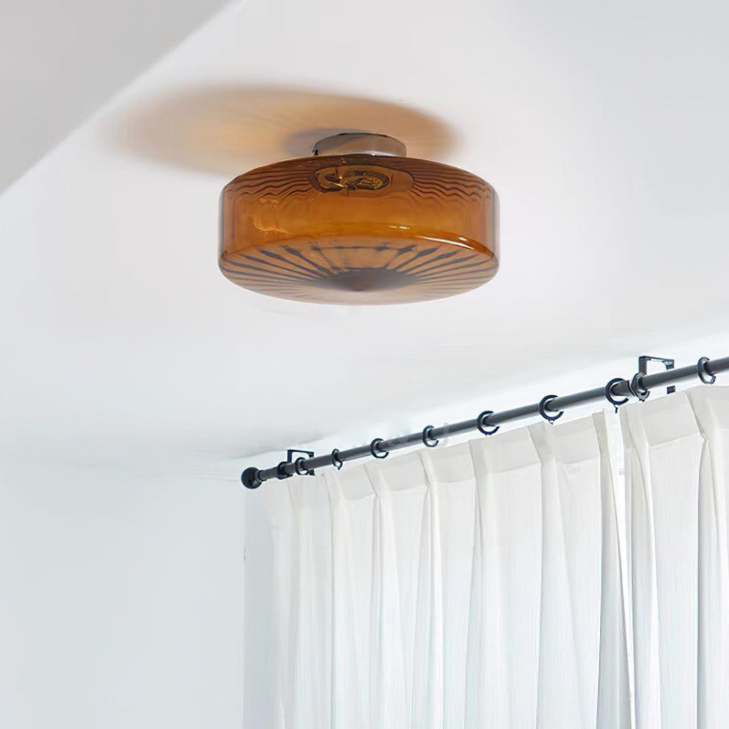 Clérachic Sunburst Amber Glass Flush Mount Ceiling Light fitted close to the ceiling above white curtains hung on a slim black rod.