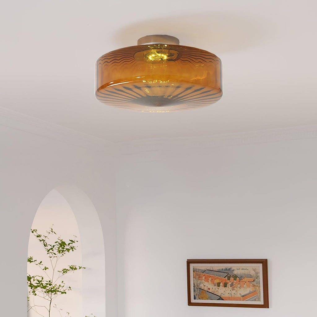Clérachic Sunburst Amber Glass Flush Mount Ceiling Light glowing in a living room with an arched doorway and a framed landscape print.