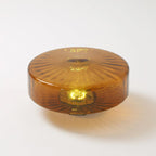The Clérachic Sunburst Amber Glass Flush Mount Ceiling Light shown off the ceiling, its drum profile and pressed sunburst face in full view.