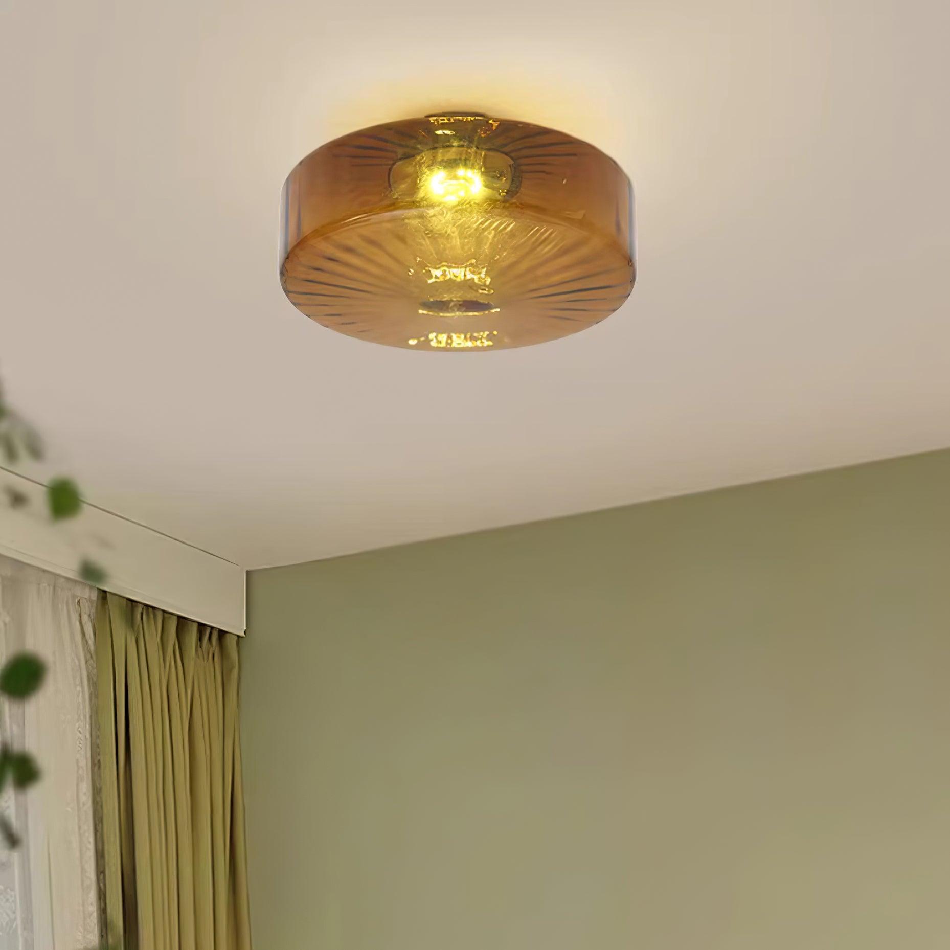 Clérachic Sunburst Amber Glass Flush Mount Ceiling Light lighting a corner where a sage-green wall meets olive curtains.
