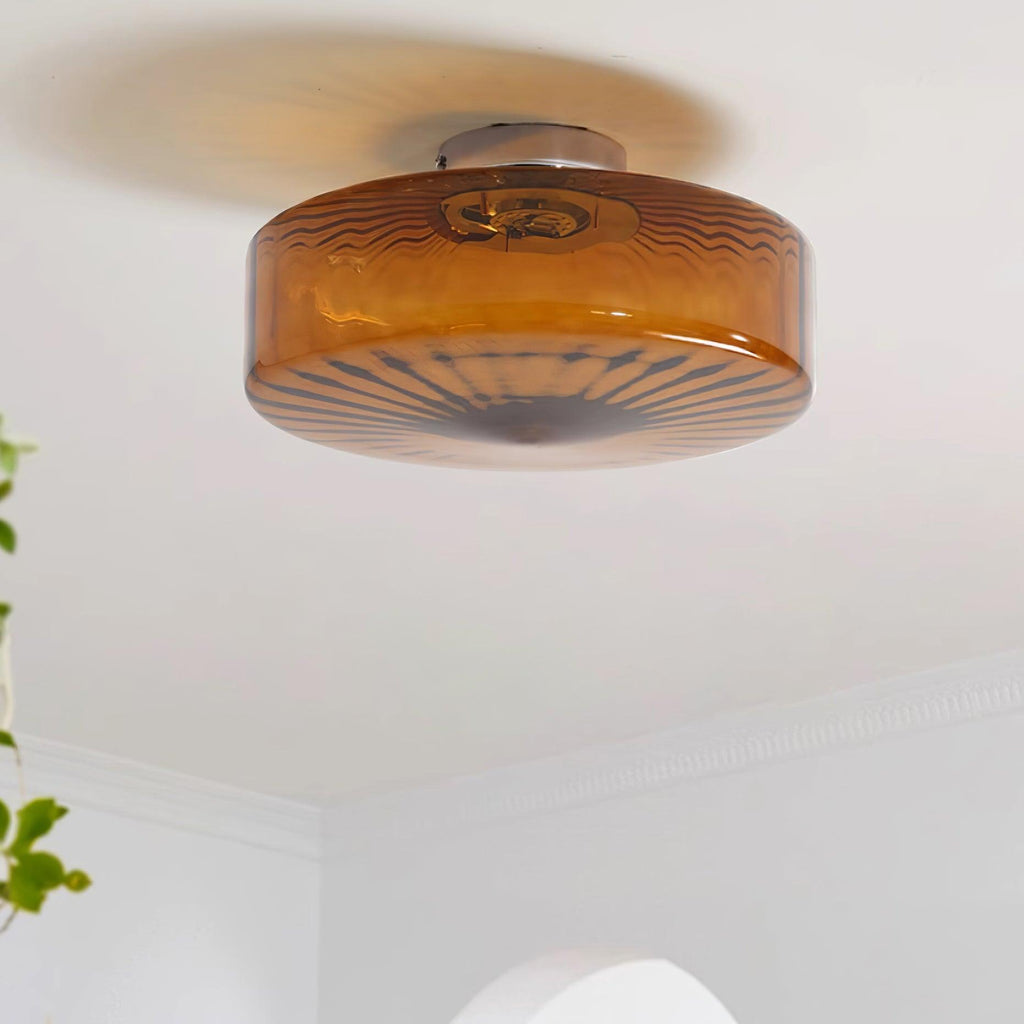 Clérachic Sunburst Amber Glass Flush Mount Ceiling Light on a hallway ceiling, trailing ivy in the frame and moulding along the wall.
