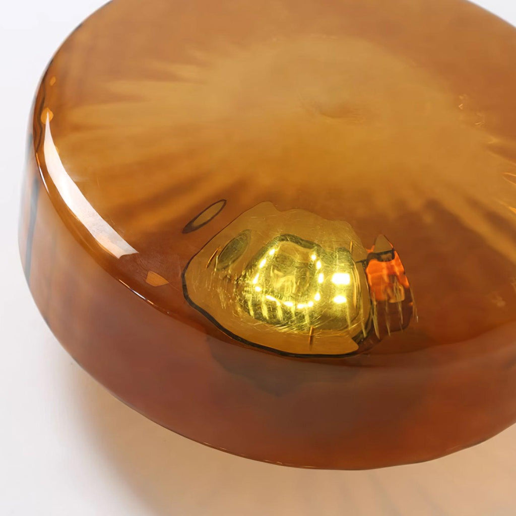 Close-up of the Clérachic Sunburst Amber Glass Flush Mount Ceiling Light, the integrated LED module glowing through thick amber glass.