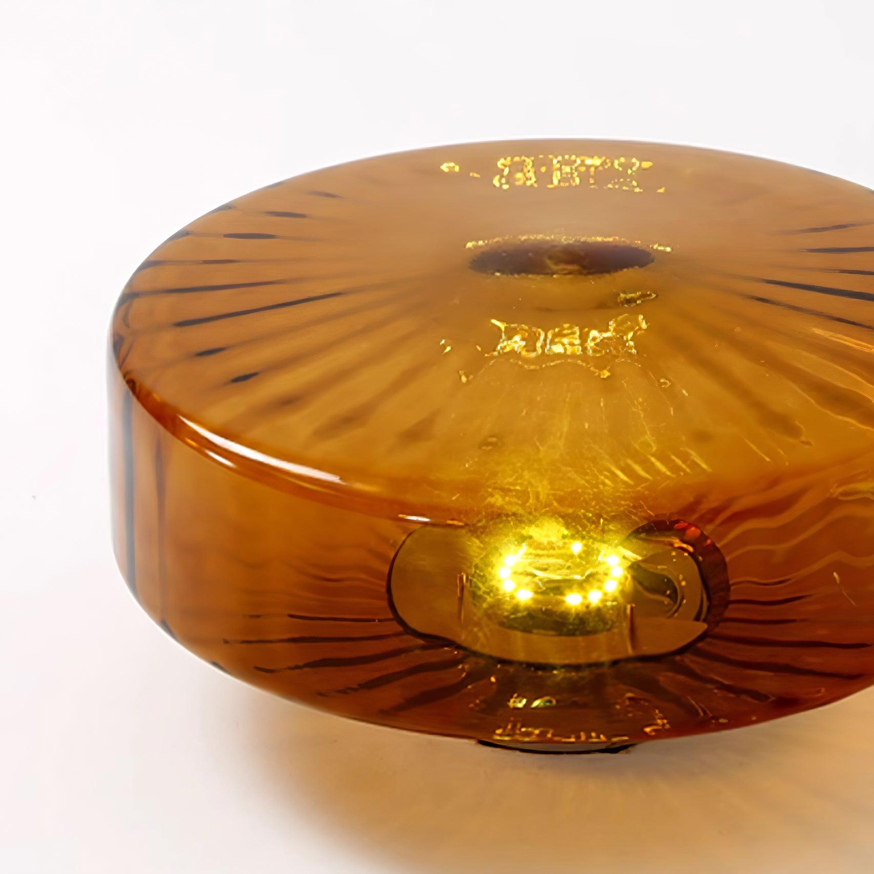 Detail of the Clérachic Sunburst Amber Glass Flush Mount Ceiling Light showing the ripple band around the rim and the radial ribs beneath.