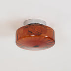 Unlit, the Clérachic Sunburst Amber Glass Flush Mount Ceiling Light shows its rust-red marbled glass against a plain white ceiling.