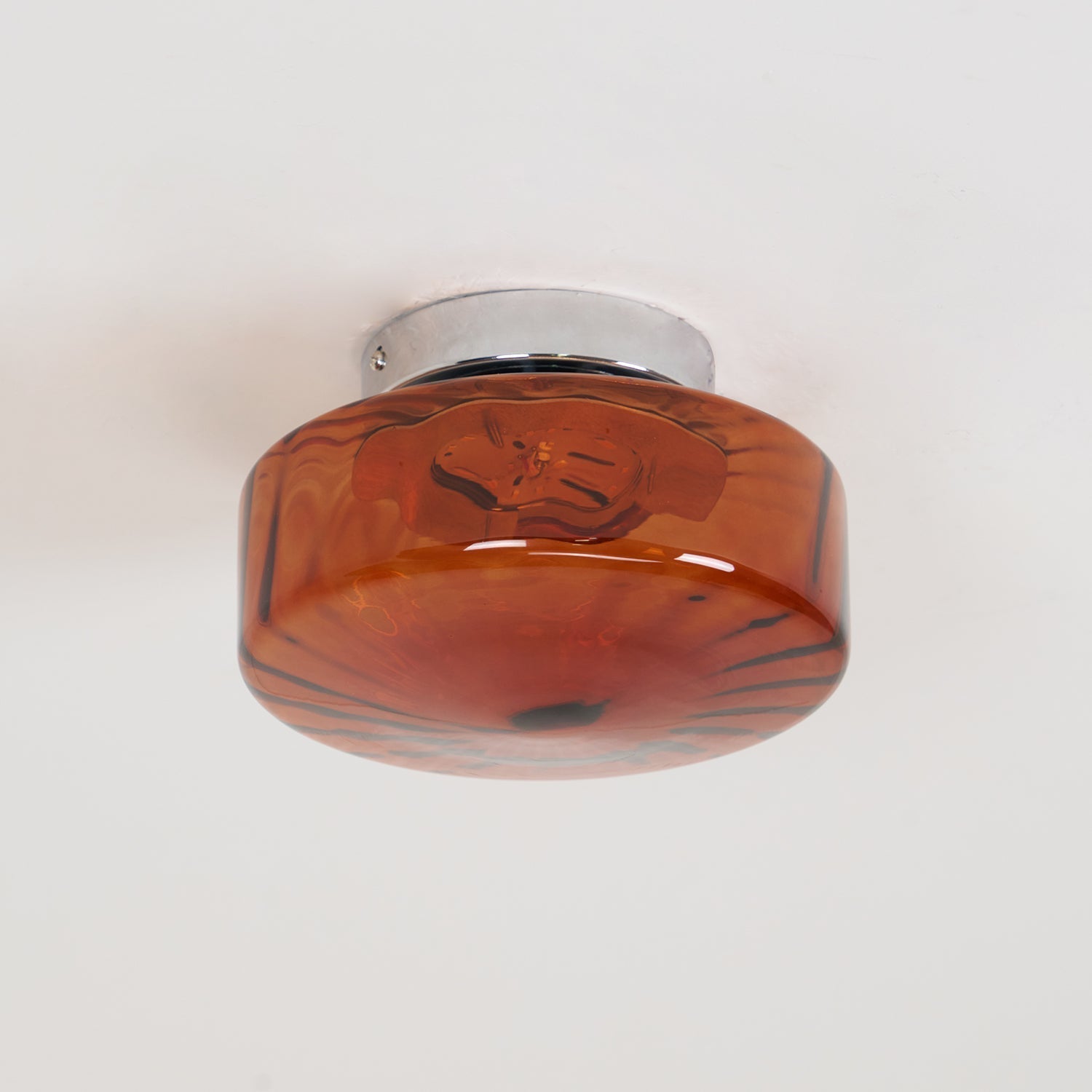 Unlit, the Clérachic Sunburst Amber Glass Flush Mount Ceiling Light shows its rust-red marbled glass against a plain white ceiling.