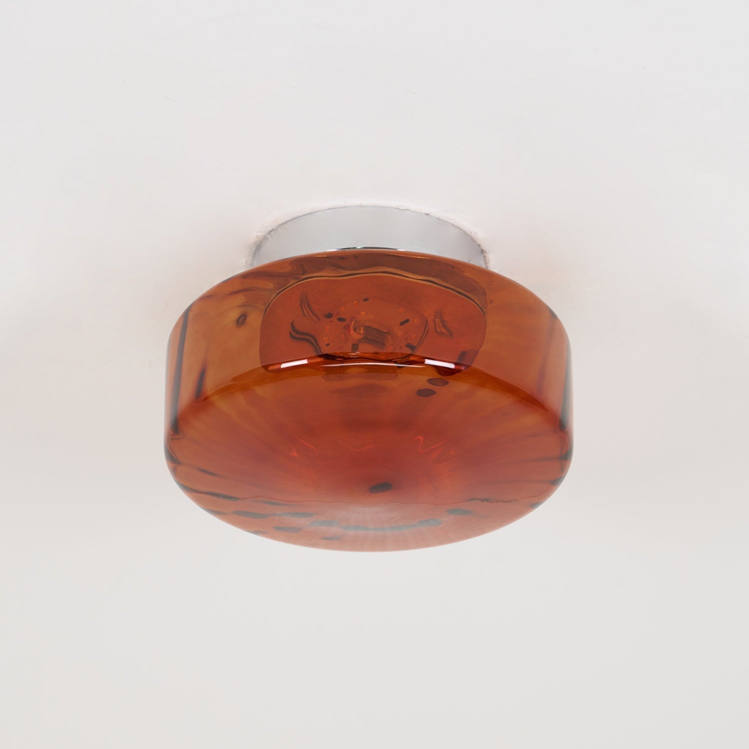 The Clérachic Sunburst Amber Glass Flush Mount Ceiling Light switched off, its chrome canopy fixed flat against the ceiling.