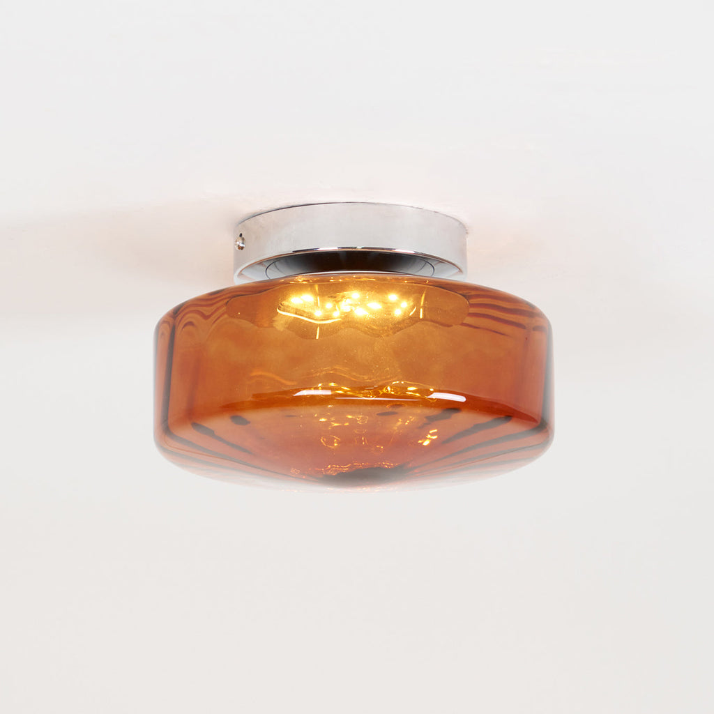 Side view of the Clérachic Sunburst Amber Glass Flush Mount Ceiling Light, showing the shallow drum and the chrome mounting canopy.