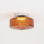 Side view of the Clérachic Sunburst Amber Glass Flush Mount Ceiling Light, showing the shallow drum and the chrome mounting canopy.