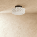 Clérachic white flush ceiling light unlit, fluted glass shade with raised beads and an embossed sunburst base, black canopy.