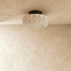 Clérachic cream flush ceiling light unlit, a fluted glass shade with raised beads and a sunburst base on a black canopy.