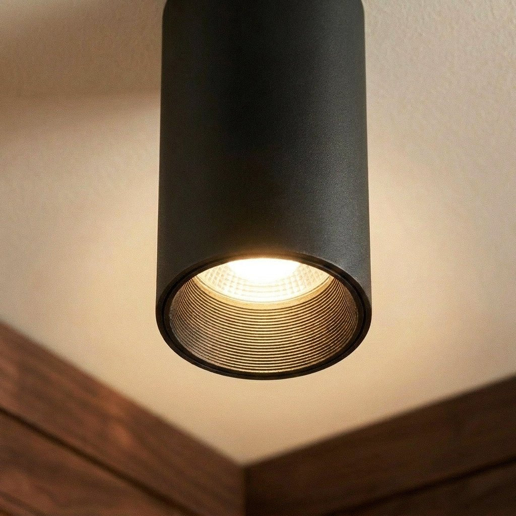 Clérachic surface downlight detail in matte black aluminium shows its warm LED and ribbed reflector up close.