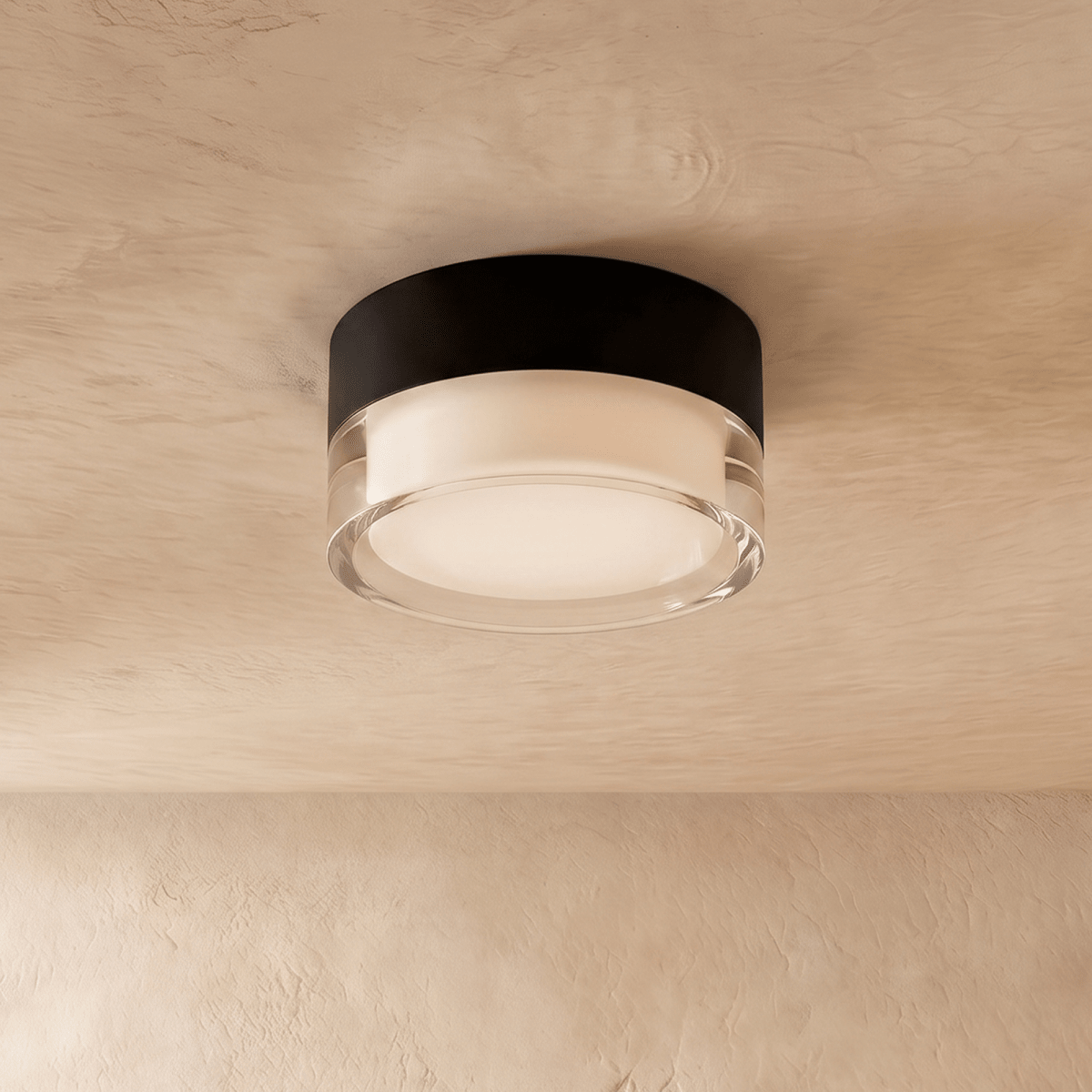 Clérachic black round flush ceiling light with a clear acrylic edge and frosted diffuser, mounted on a limewash ceiling.